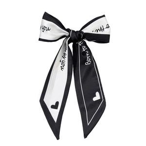 Elegant black and white satin ribbon bow hair clip with chic heart and text patterns