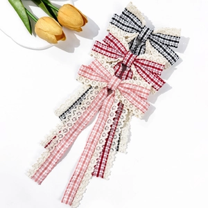 Three-piece plaid bow hair clip set with lace tassels in black, red, and pink patterns