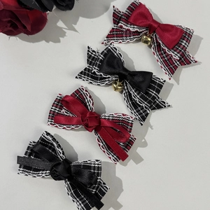 Checkered bow hair clips with red and black ribbons and gold bell decorations