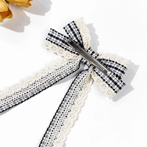 Elegant plaid lace bow hair clip with long ribbons and checkered pattern on white background