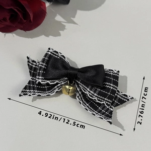 Detail view of plaid bow hair clip with golden bell and dimensions 4.92 x 2.76 inches