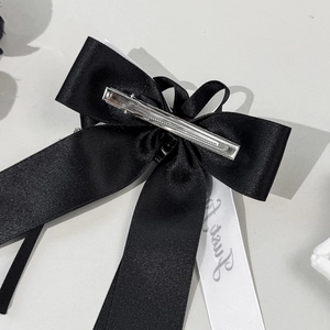 Black satin ribbon bow hair clip with silver crocodile clip and white Sunny lettering