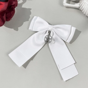 Gothic style white satin bow hair clip with silver star pendant and edgy punk aesthetic