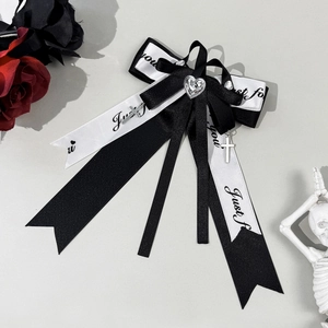 Gothic bow hair clip with silver heart and crosses against a dark rose background
