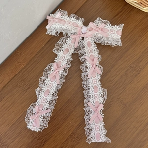 Gros plan sur le nœud en dentelle Lolita avec rubans roses et détails de franges