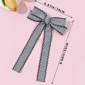 Grey tweed bow hair clip with black stitching, dimensions 5.51 inches by 8.66 inches