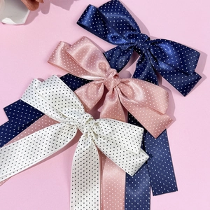 Polka dot satin bow hair clips set in navy blue, light pink, and white with long ribbons