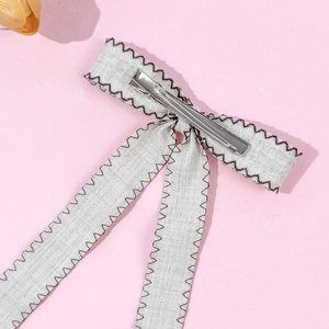 Elegant vintage bow hair clip with grey fabric and silver metal alligator clip detail