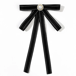 British style black bow tie brooch with faux pearl center and white stitching detail