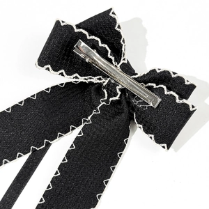 Elegant black ribbon hair clip with white zigzag stitching and metal alligator clasp