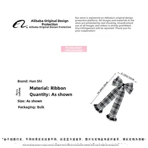 Detailed view of large plaid bow hairclip with lace edges and ribbon streamer details