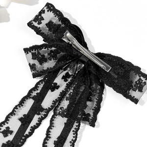 Elegant black lace bow hair clip with silver metal alligator grip on white background