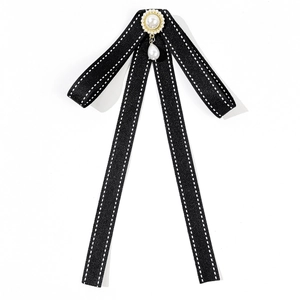 Elegant black bow tie brooch with white stitching and hanging teardrop pearl accents