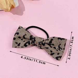 Detailed view of leopard print bow hair tie with size measurements 11.5cm by 7.5cm