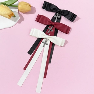 Gothic style bow brooch with silver cross pendant in black, red and white colors
