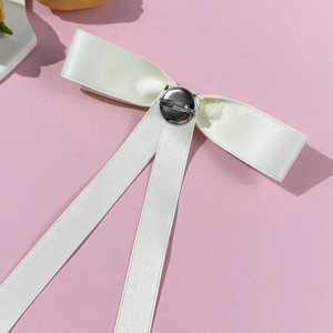 Elegant white satin bow brooch with cross design and silver metal pin closure