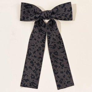 Detail of vintage leopard print long tail bow hair clip in dark grey denim fabric