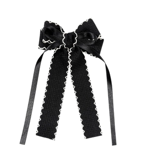 Elegant black bow hair clip with white scalloped edge for women and classic hair styling