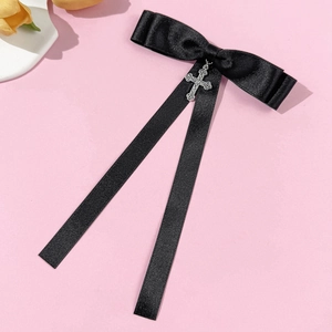 Gothic black satin bow brooch with vintage silver cross pendant and long ribbons