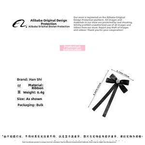 Detailed view of the black ribbon bow brooch featuring a silver rose metal center buckle