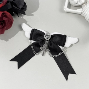 Gothic bow hair clip featuring white angel wings with silver chain and cross heart detail