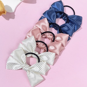 Chic polka dot bow hair ties in navy, pink, and white satin for stylish women's hairstyles