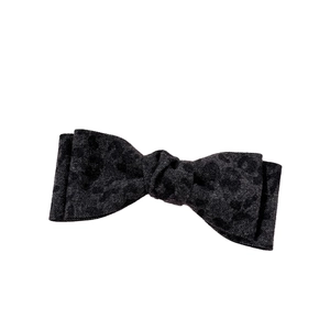Vintage leopard print bow hair clip with dark grey textured fabric on white background