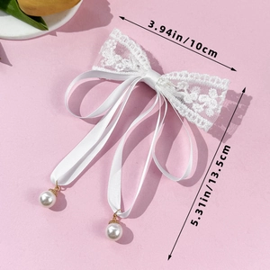 Detailed dimensions of white lace bow hair clip with faux pearl pendants on pink background