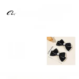 Close-up of black ribbon bow hair clips with faux pearls showing 11cm by 6.5cm dimensions