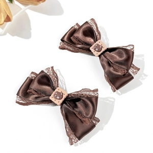 Elegant pair of brown satin bow hair clips with lace trim and cute bear cookie charm