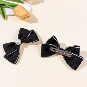 Elegant black bow hair clips with white pearls and gold metal duckbill grip for women