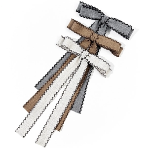 Three-piece linen ribbon bow hair clips in grey, brown, and cream with black stitch edge