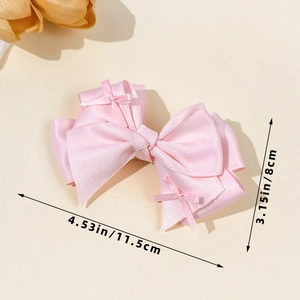 Pink layered satin bow hair clip measuring 11.5cm by 8cm with elegant texture