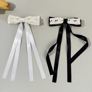 Elegant lace bow hair clips with heart patterns and long satin ribbons in black and white