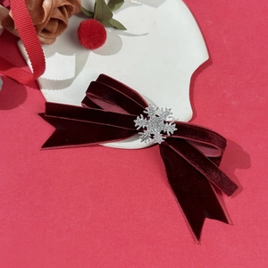 Velvet Christmas bow hair clip in deep red with sparkling silver snowflake detail