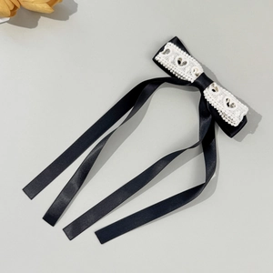 Elegant black ribbon bow hair clip with white heart lace and long flowing streamers