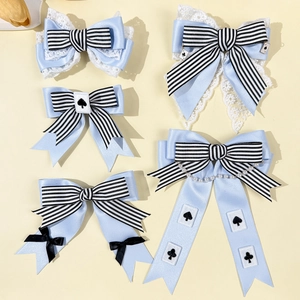 Light blue Lolita hair clips with stripes, lace, and poker card charms in a set