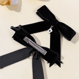 Velvet bow hair clips with poker card pendant on a minimalist beige background