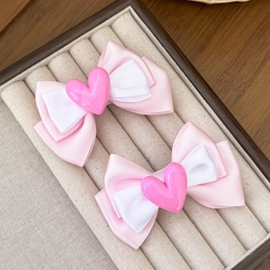 Pink and white ribbon bow hair clips with heart resin centerpiece for girls' hairstyles