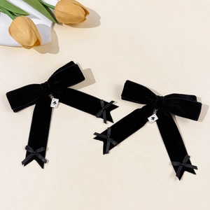 Detail view of velvet bow hair clips with Ace of Clubs poker charms in vintage style