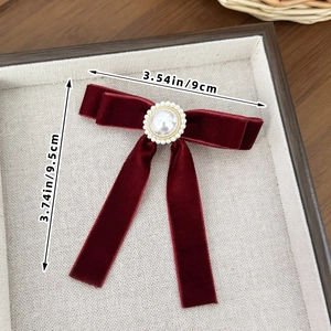 Elegant wine red velvet bow hair clip with central pearl and rhinestone detailing