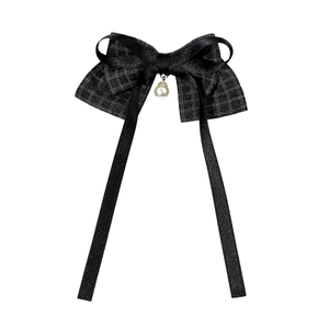 Plaid bow hair clip with long ribbons and a pearl pendant on a white background
