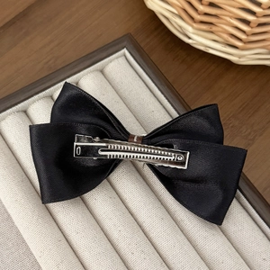 Elegant black satin ribbon bow hair clip with a secure silver metal alligator grip