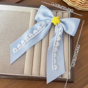 Detailed view of the blue Lolita bow hair clip with white lace trim and star detail