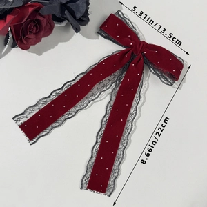 Detail view of red velvet bow hair clip with lace and pearls showing 22cm length size