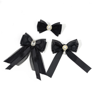Elegant black lace bow brooch set with pearls and crystals for a sophisticated style