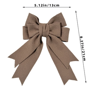 Brown bow hair clip with textured fabric, double-layer design and long ribbon streamers