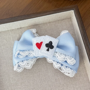 Blue Lolita hair clip with white lace trim and embroidered poker cards on fabric