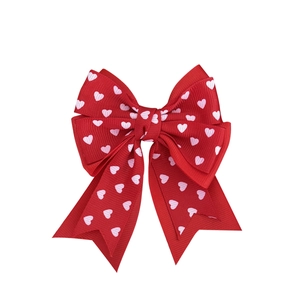 Sweet red hair bow clip with white heart patterns and double-layered ribbon tails
