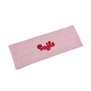 Pink ribbed knit sports headband with a red Smile print for yoga and fitness training